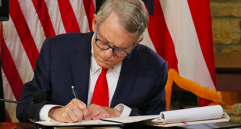 Governor Mike DeWine working at desk.